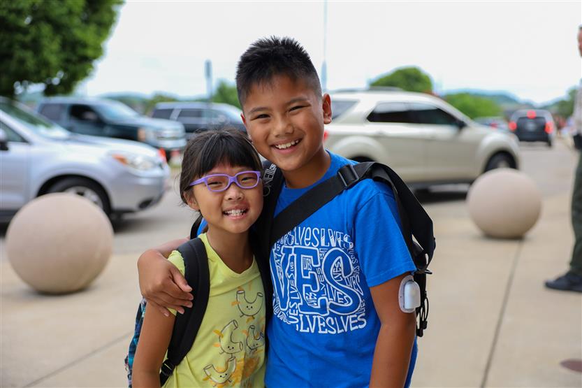 Two students smile